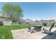 Serene backyard featuring a patio with outdoor seating, lush green grass, and a privacy fence at 329 Dogwood Dr, Pendleton, IN 46064