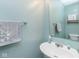 Stylish half-bathroom featuring a modern sink, ample toilet paper, and decorative fixtures against light blue walls at 329 Dogwood Dr, Pendleton, IN 46064
