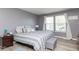 Cozy bedroom features a queen-sized bed, natural light, and calming gray walls at 329 Dogwood Dr, Pendleton, IN 46064