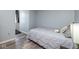 Comfortable bedroom showcasing a plush queen-sized bed, gray walls, with an at-home workout treadmill in the corner at 329 Dogwood Dr, Pendleton, IN 46064