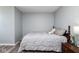 Cozy bedroom featuring a queen-sized bed with wood trim and neutral gray walls, a warm inviting atmosphere at 329 Dogwood Dr, Pendleton, IN 46064