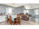 Dining area with seating for six, adjacent to the living room and kitchen, with modern lighting at 329 Dogwood Dr, Pendleton, IN 46064