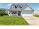 Charming two-story home featuring a front porch, well-maintained lawn, and attached two-car garage at 329 Dogwood Dr, Pendleton, IN 46064