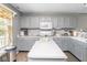 Well-lit kitchen with a large center island, gray cabinets, and modern appliances at 329 Dogwood Dr, Pendleton, IN 46064