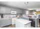 Bright kitchen featuring gray cabinets, a center island, and stainless steel appliances at 329 Dogwood Dr, Pendleton, IN 46064