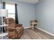Comfortable living room featuring a cozy recliner chair, floor lamp, and a window at 329 Dogwood Dr, Pendleton, IN 46064