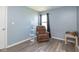 Relaxing living room with a cozy recliner chair, floor lamp, and a window providing natural light at 329 Dogwood Dr, Pendleton, IN 46064