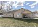 Well maintained backyard with a covered patio on a single story brick home at 34 David Ln, Indianapolis, IN 46227