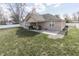 Expansive backyard view, showcasing a covered patio area with ample green space, perfect for outdoor activities at 34 David Ln, Indianapolis, IN 46227