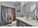 Bathroom with vanity, decorative shower curtain, and round mirror at 34 David Ln, Indianapolis, IN 46227