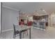Open dining area with tile floors, gray walls, flows into living room with view of kitchen island at 34 David Ln, Indianapolis, IN 46227