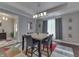 Elegant dining room featuring a modern light fixture, a wood floor, and neutral wall color at 34 David Ln, Indianapolis, IN 46227