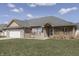 Charming brick home featuring an attached garage and a well-manicured lawn, complemented by a clear blue sky at 34 David Ln, Indianapolis, IN 46227