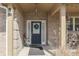 Inviting front porch featuring a decorative front door with wreath and seating, perfect for relaxing at 34 David Ln, Indianapolis, IN 46227