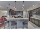 View of open kitchen with granite countertops, stainless appliances, breakfast bar, and dark wood cabinets at 34 David Ln, Indianapolis, IN 46227