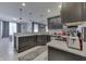 Spacious kitchen featuring dark cabinetry, granite countertops and stainless steel appliances, open to dining area at 34 David Ln, Indianapolis, IN 46227