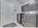 Laundry Room with front loading washer and dryer, plus gray cabinets at 34 David Ln, Indianapolis, IN 46227