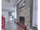 Cozy living room with a stone fireplace creating a warm and inviting ambiance with seamless flow to other areas at 34 David Ln, Indianapolis, IN 46227
