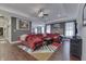Spacious living room with stone fireplace, hardwood floors, and a ceiling fan offering a cozy, inviting atmosphere at 34 David Ln, Indianapolis, IN 46227