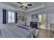 Bright main bedroom features tray ceiling, ceiling fan, hardwood floors and ensuite bathroom access at 34 David Ln, Indianapolis, IN 46227