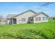 A well-maintained single-story home with brick accents, shutters, and a green lawn at 3925 Oak Harbor Ln, Indianapolis, IN 46237
