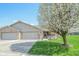 Charming single-story home featuring a well-manicured lawn, flowerbeds, and an attached two-car garage at 3925 Oak Harbor Ln, Indianapolis, IN 46237