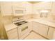 Cozy kitchen featuring white cabinets, appliances, and countertops at 3925 Oak Harbor Ln, Indianapolis, IN 46237