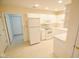Bright kitchen with white appliances, cabinets, and a clean floor at 3925 Oak Harbor Ln, Indianapolis, IN 46237