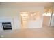 Open-concept living area with a fireplace and view into the well-lit kitchen at 3925 Oak Harbor Ln, Indianapolis, IN 46237