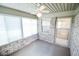 Bright and airy screened porch featuring a ceiling fan and access to the outside at 3925 Oak Harbor Ln, Indianapolis, IN 46237