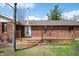 Backyard with wooden deck, brick siding and chimney against a blue sky at 4411 W Friar Dr, Muncie, IN 47304