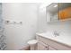 Bathroom with white sink, toilet, mirror, and medicine cabinet at 4411 W Friar Dr, Muncie, IN 47304