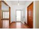 Inviting entryway with wood floors, closet and view of large living room at 4411 W Friar Dr, Muncie, IN 47304