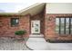 Close up of the front entrance with charming brickwork and updated trim at 4411 W Friar Dr, Muncie, IN 47304