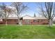 Charming brick ranch home with a well-manicured lawn and mature trees at 4411 W Friar Dr, Muncie, IN 47304