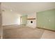 Spacious living room featuring a brick fireplace and neutral carpeting at 4411 W Friar Dr, Muncie, IN 47304