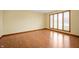 Bright living room features wood floors, trim, and large window at 4411 W Friar Dr, Muncie, IN 47304