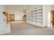 Open-concept living room with fireplace, built-in shelving, and open kitchen at 4411 W Friar Dr, Muncie, IN 47304