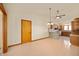 Open living space with view into the kitchen, updated lighting, and a ceiling fan at 4411 W Friar Dr, Muncie, IN 47304