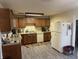 Functional kitchen featuring wood cabinets, modern appliances, and durable floors, providing ample space for cooking at 445 E 1000 N, Alexandria, IN 46001