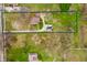 Aerial view of a property with a large green lot, bordered with a blue line, and a house with a long driveway at 453 S High School Rd, Indianapolis, IN 46241