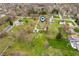 Aerial view of a house surrounded by lush trees and greenery in a serene neighborhood at 453 S High School Rd, Indianapolis, IN 46241