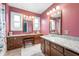 Well-lit bathroom with double vanities, granite countertops, and white tile flooring at 453 S High School Rd, Indianapolis, IN 46241