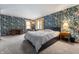 Cozy bedroom featuring bright floral wallpaper and neutral carpet flooring at 453 S High School Rd, Indianapolis, IN 46241