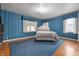 Comfortable bedroom with hardwood floors, light, and a king-sized bed at 453 S High School Rd, Indianapolis, IN 46241