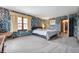 Spacious bedroom with bright floral wallpaper, carpet, and natural light at 453 S High School Rd, Indianapolis, IN 46241