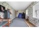 Spacious bonus room with bright, floral wallpaper and neutral carpet flooring at 453 S High School Rd, Indianapolis, IN 46241