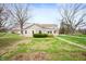 Well-maintained home with a large front yard, mature trees, and a traditional design at 453 S High School Rd, Indianapolis, IN 46241