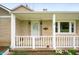Close-up of the covered front porch with a white railing and inviting entrance at 453 S High School Rd, Indianapolis, IN 46241
