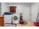 Functional laundry room equipped with a washer, dryer, and extra storage space at 453 S High School Rd, Indianapolis, IN 46241